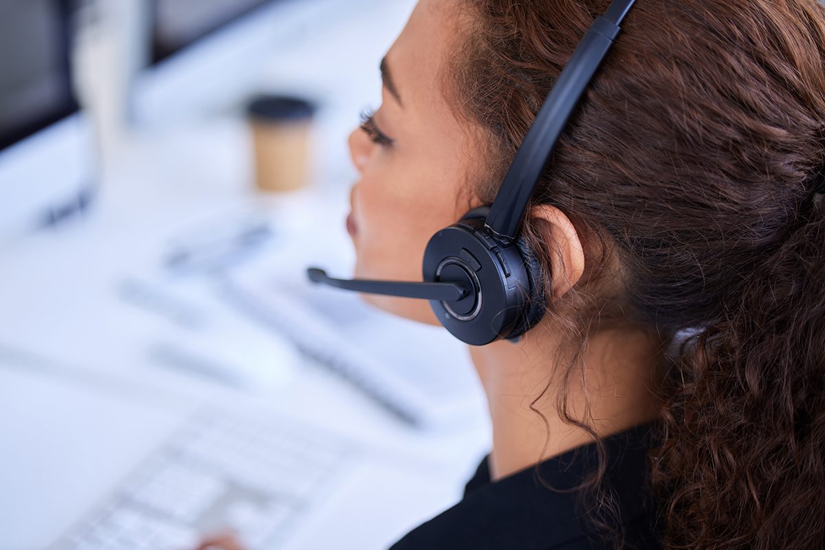 A view from above and behind a customer service representative using a VoIP phone line.